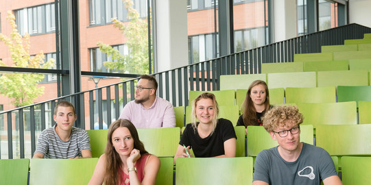 A group of students is sitting in a lecture hall